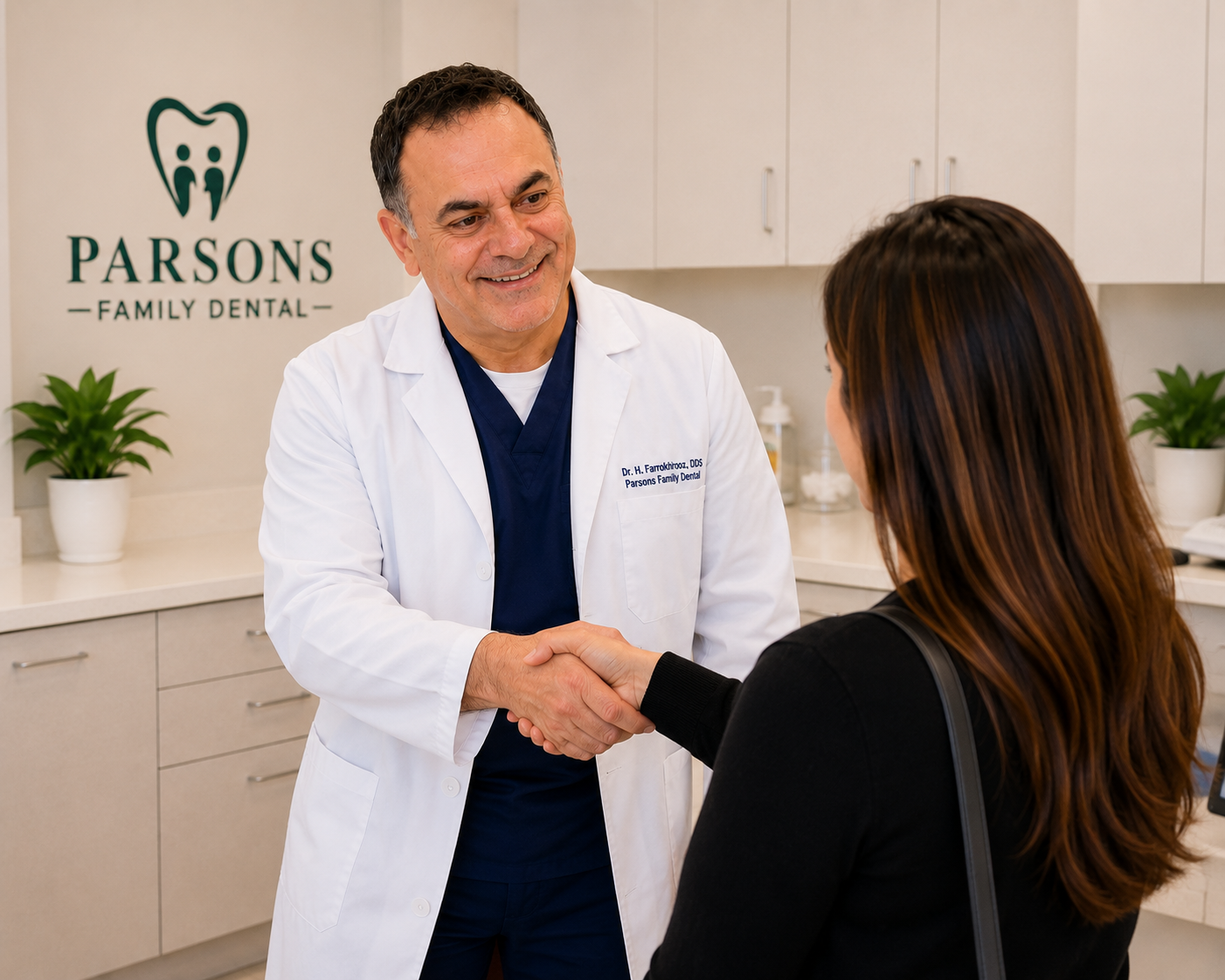 Dr. H.R. Farrokhrooz welcoming a patient at Parsons Family Dental